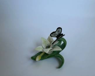 Sculpture of butterfly resting on Lily