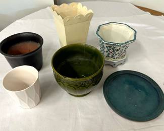 Assorted planters and plant pots with a saucer