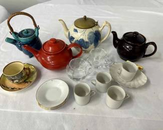 4 teapots and teacups and saucers