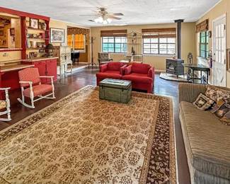 Lovely red chairs, rocking chairs, sofa and area rugs