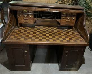 Antique roll top desk with unique desk surface. In excellent condition except for modernized cable access holes drilled through sides. Roltop slides easily. Oak and ready for a polish. Right side lock has no key. We will search house for it.
