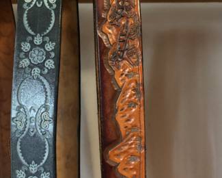 Close up of hand tooled leather belts.