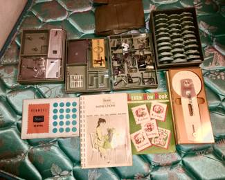 Attachments, tools, cams, instruction book for sewing machine.