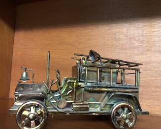 Copper fire engine music box. Plays “Smoke Gets In My Eyes”.
