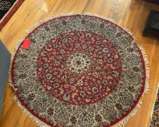 Round red and beige rug diameter: 50” $100 + tax