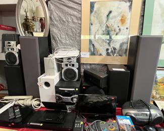 Electronics, 2 sets of speakers, DVD/Blue-ray players, Power strips, boom boxes. Mirror and 5th framed original watercolor.