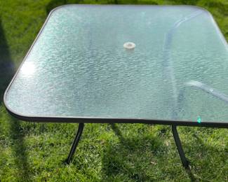 Square glass top patio table.