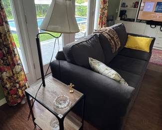 Table with lamp. Sofa.