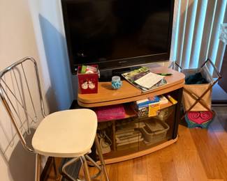 . . . another flat-screen TV and TV stand -- retro stool