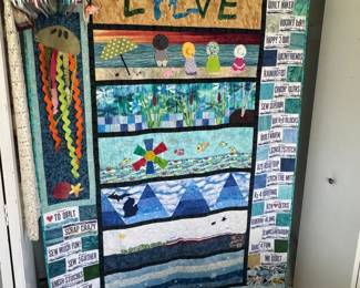Large Quilt with Michigan "quilting" & "sewing" headliner blocks in shape of license plates - this is hanging on the a closet rod as shown with the doors open