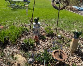 Green metal mesh table and 6 chairs in background - lots of garden art