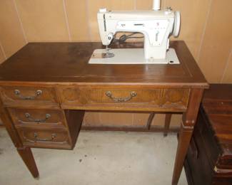 Vintage sewing machine cabinet/ machine is for repair