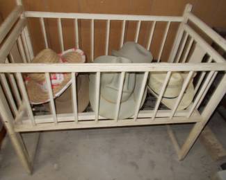 Baby crib and vintage hats