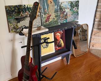Vintage artwork and a guitar.