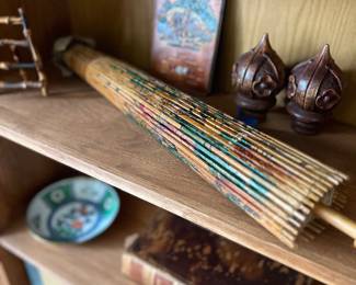 Shelf of vintage items including an Asian paper umbrella and an 1846 Bible.