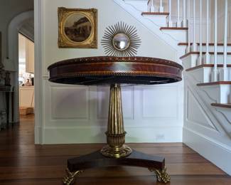 Amazing Maitland-Smith baroque table on three gilded paw feet, very detailed carved border, with Art Nouveau style floral inlay in center; dimensions: 33.5" h x 43" dia. Antique equestrian oil on canvas by listed English artist in gold gilt frame, starburst convex wall mirror.
