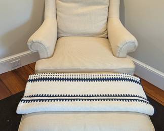 Nicely upholstered armchair and matching ottoman, w/cotton coverlet.