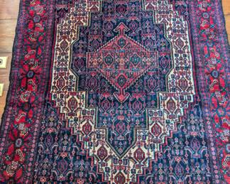 Vintage hand-woven Persian rug, measuring 3' 10" x 5' 5".