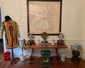 Nicely framed, large repro map of 1791 London - the framing alone was $2,500.00! The authentic uniform, worn by the Mounted Band of the Household Calvary, is mounted on a vintage French Empire side table, by Milling Road, a division of Baker Furn. Co., green enameled ceramic heater, by Maple Co., London, antique Italian trestle pegged table, hand-carved wooden elephant stool, pair of brass/ceramic bird candleholders and vintage metal Scottish post box.