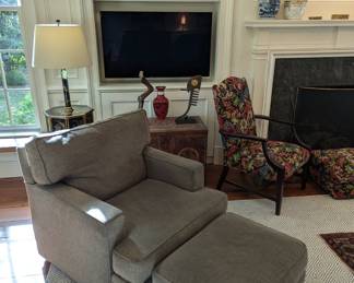 One of a pair of down-stuffed Pottery Barn upholstered chairs and matching ottomans.