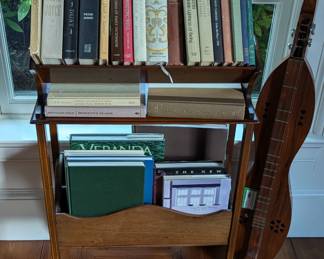 Antique English wooden bookcase, with older books and vintage walnut wood fiddle-style dulcimer, hand-made by Furman Thornton.