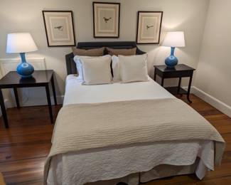 Nicely dressed queen size bed, w/matelasse coverlet, set/3 nicely framed/matted bird prints, pair of glazed ceramic table lamps and black bedside tables.
