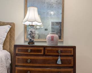 Close-up pic of the other of the pair of banded mahogany 4-drawer chests and antiqued wall mirrors, from Fred Reed