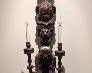 Close-up of the antique French 2-light carved wood sconces, with angel and lion motif.