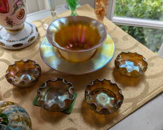 Set/4 favrile iridescent gold aurene finger bowls, attributed to Louis C. Tiffany and Steuben gold aurene calcite bowl and underplate, by Frederick Carder, England.
