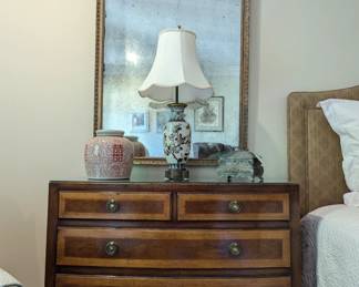 Close-up pic of one of the pair of banded mahogany 4-drawer chests and antiqued wall mirrors, from Fred Reed.