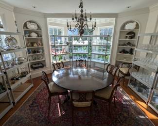 Vintage round Councill Craftsman banded mahogany pedestal dining table, with set/8 carved wood chairs (2 arm, 6 sides) with cane bottoms and custom-made seat cushions atop a hand-woven vintage Persian Tabriz rug, measures 10' 3" x 7' 4'.