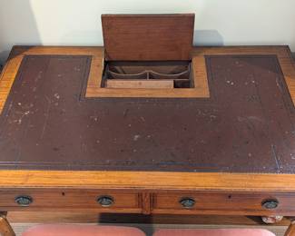 Antique French inlaid fruitwood writing desk, w/leather top, hidden letter drawer, on brass casters.