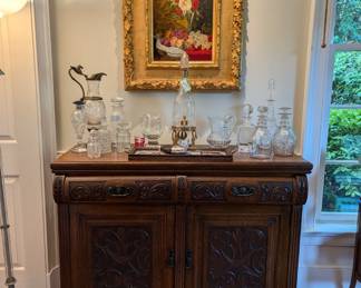 Antique English carved oak chest, with original brass pulls and collection of cut crystal barware.