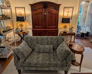 One of the pair of loveseats, covered in Brunschwig and Fils fabric, Louis Philippe oval table, w/marquetry and inlay, single drawer and bottom shelf, ca. 1850, from William Word Antiques, contemporary round wooden table, by Robinsons, from Holland, pair of custom-made table lamps, by Paul Smith, pair of nicely framed/matted, hand-painted watercolor birds, ca. 1870 and pair of Asian porcelain cachepots, w/fresh orchids.