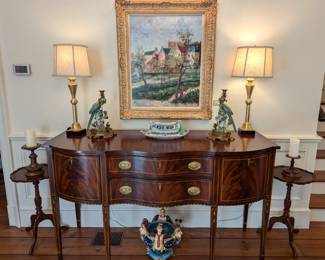 Vintage inlaid flame mahogany Federal style Henkel-Harris sideboard, pair of gold gilt candlestick table lamps, w/shades, finials, pair of green parrot/brass candleholders, nicely framed original oil on canvas, by listed Viennese artist, Alexander Kardin, pair of mahogany 3-legged candlestick tables, Majolica jardiniere, and antique English porcelains.
