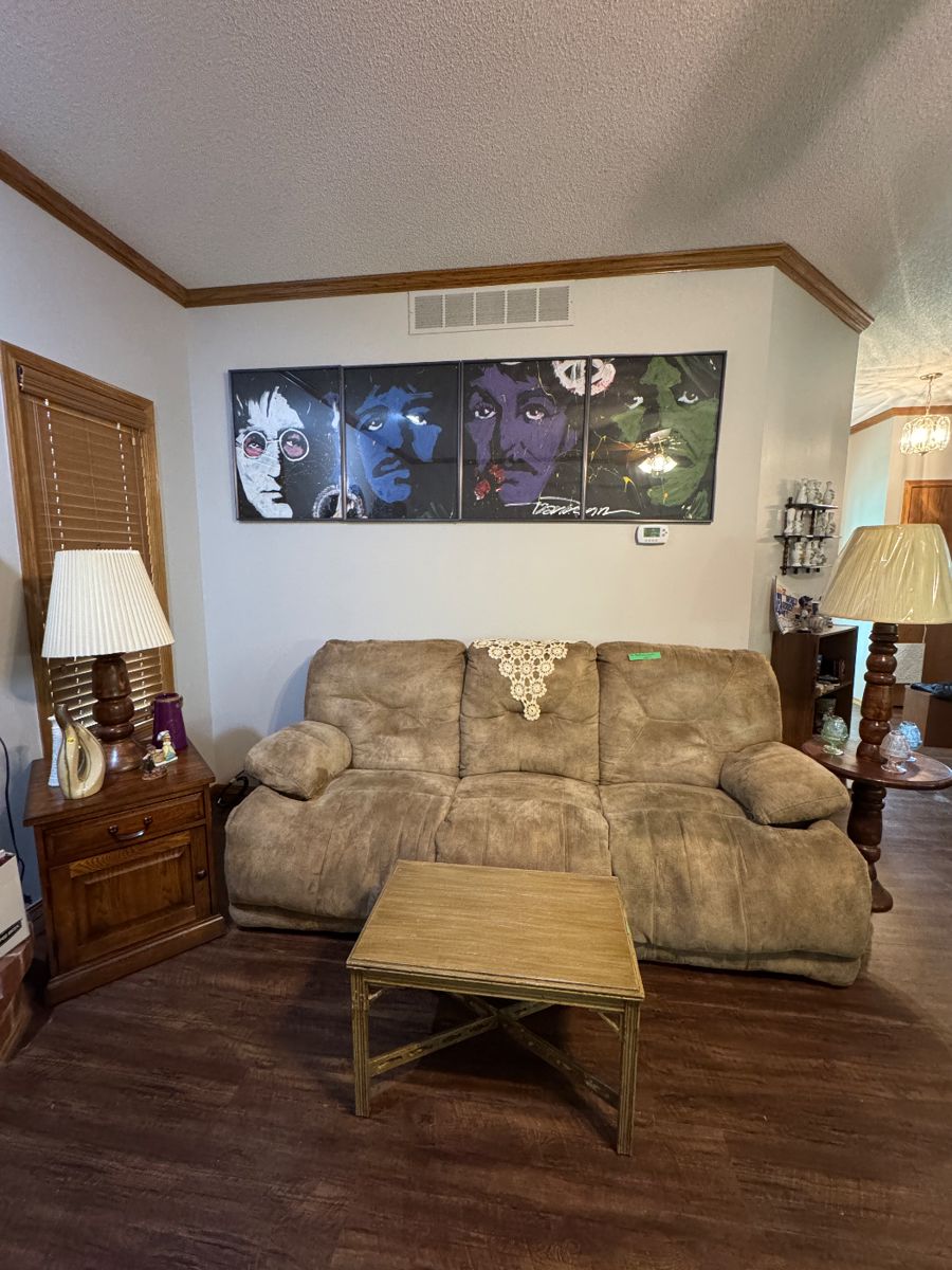 Beatles pictures, reclining couch and chair.