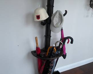 Antique hall tree with hats and umbrellas