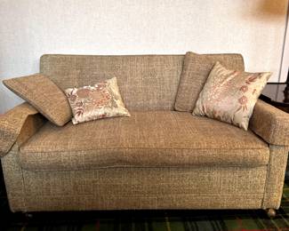 Vintage loveseat with twin hide-a-bed, on brass casters.