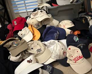 Tons of golf and ball caps, many autographed 
