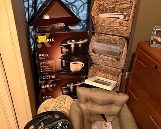 Keurig machines, Angry Birds suitcase, and wicker display/storage