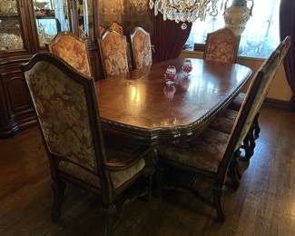 Stunning inlaid dining table with two leaves and ten chairs. Matching lighted China cabinet is also available.