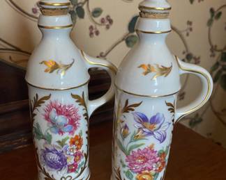Pair of antique 19th-century bone china vanity perfume bottle decanters with floral and gold gilt designs.