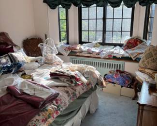 Room full of vintage linens embroidered and new linens , vintage aprons
