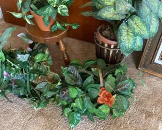An Old Wood Milking Stool And Four Artificial Plants