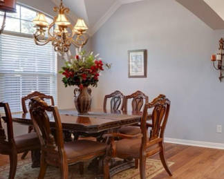 Oak 5 piece Dinning table with extension pieces+ two arm chairs. & artificial flowers and vase.