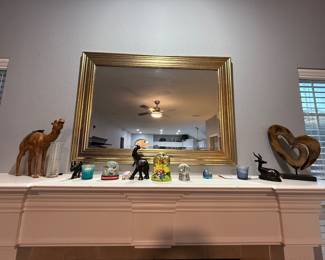 Decorative mirror with precious art and collectibles.