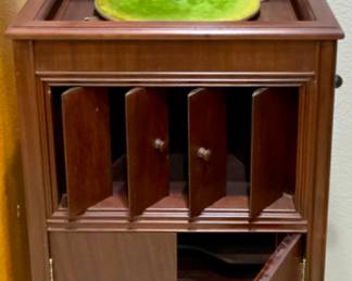 Columbia Grafonola, an early 20th-century (1907-1915) record player manufactured by the Columbia Graphophone Company. Features an internal horn concealed within a cabinet, designed to resemble fine furniture.
The cabinet includes louvred doors for volume control and hand-cranked spring motor.