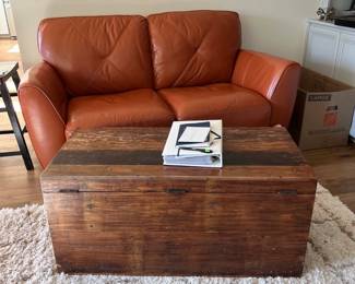 Leather loveseat and wooden coffee table