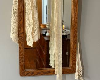 Pretty lace pieces on oak framed mirror