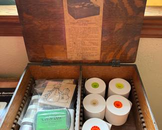 Stamps and ink, paper printer rolls, vintage wood box